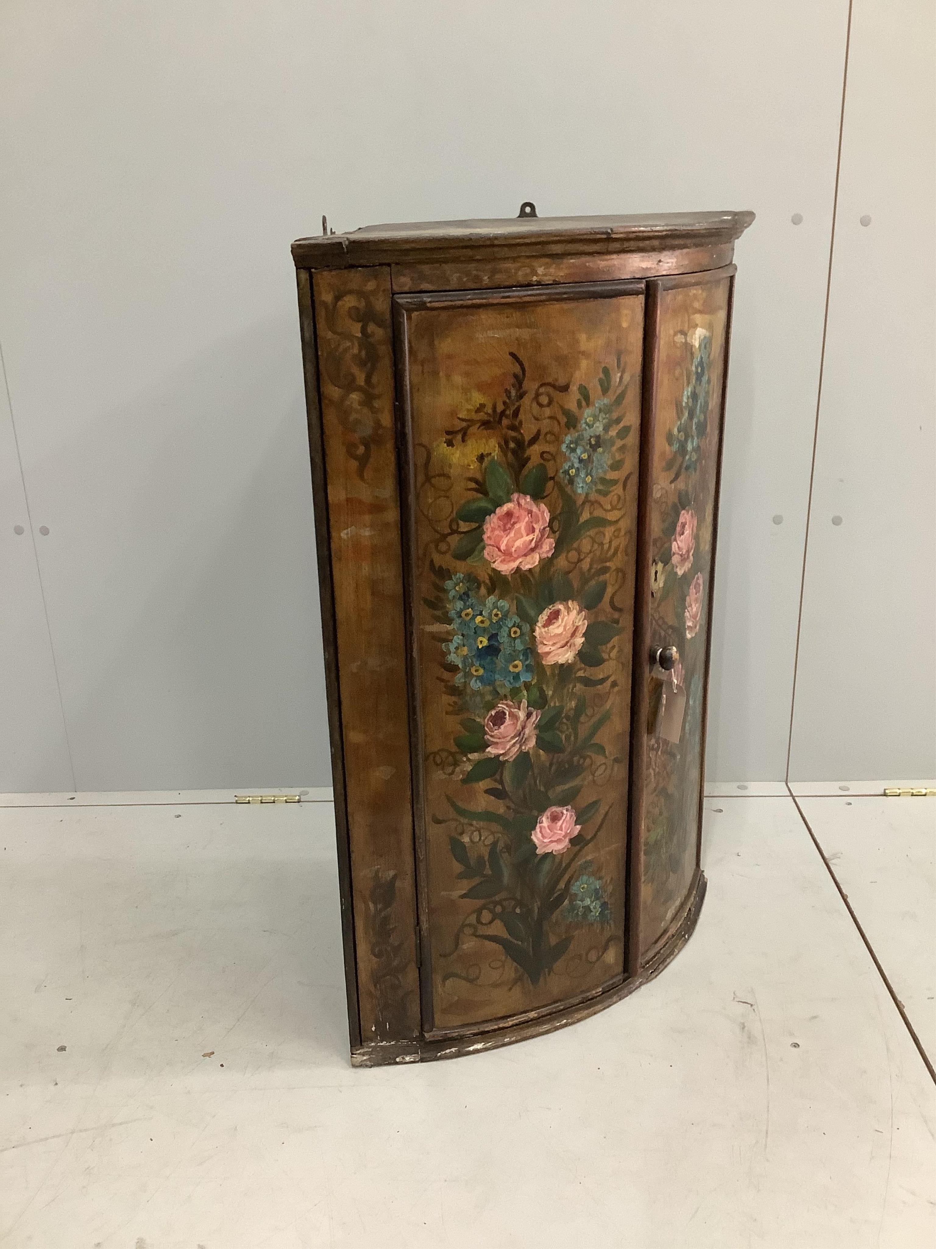 An 18th century Dutch bowfront hanging corner cupboard, later painted, width 66cm, depth 45cm, height 92cm. Condition - fair